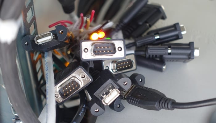 A close-up view shows several cables with various connectors grouped together. The cables are all black.